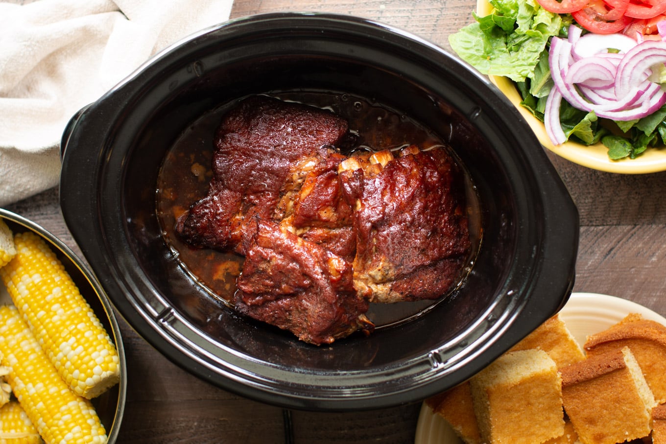 Cooked baby back ribs in a slow cooker.