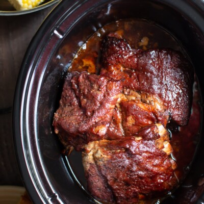 ribs in the slow cooker, cooked with barbecue sauce on top.