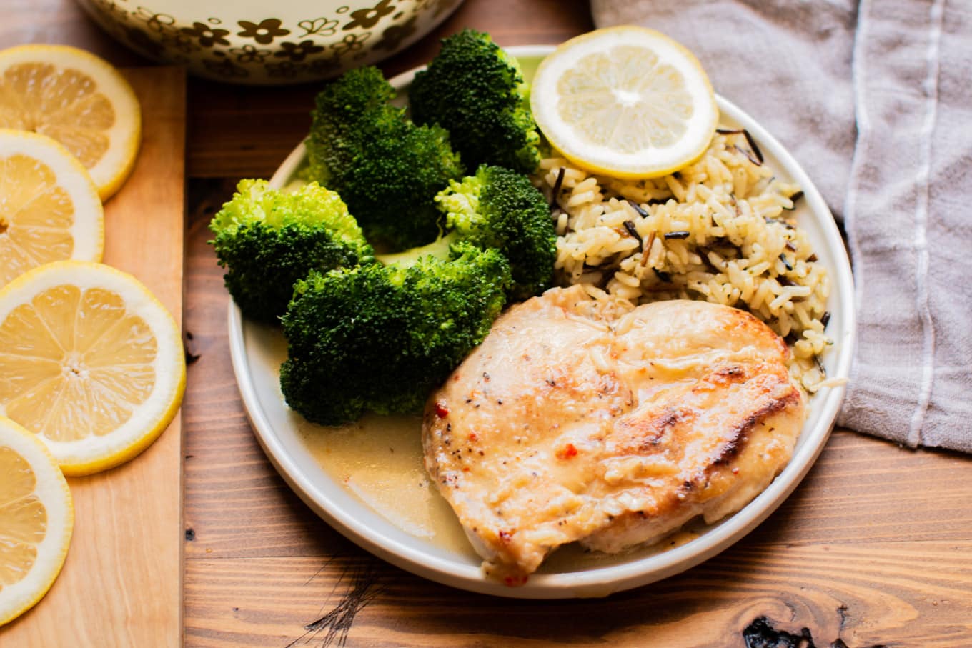 Gray plate with lemon chicken breast, broccoli and rice pilaf.