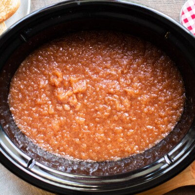Cooked cinnamon applesauce in a slow cooker.