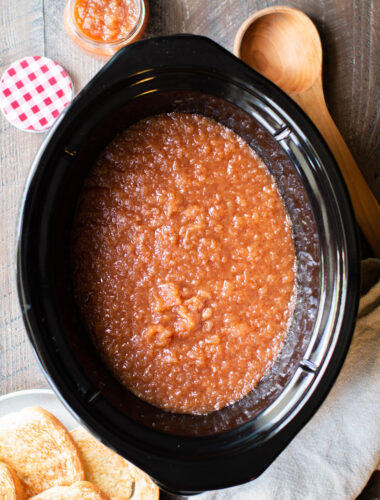 Applesauce in a slow cooker with toast on the side.