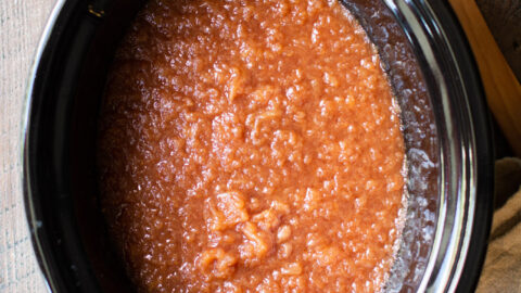 Applesauce in a slow cooker with toast on the side.