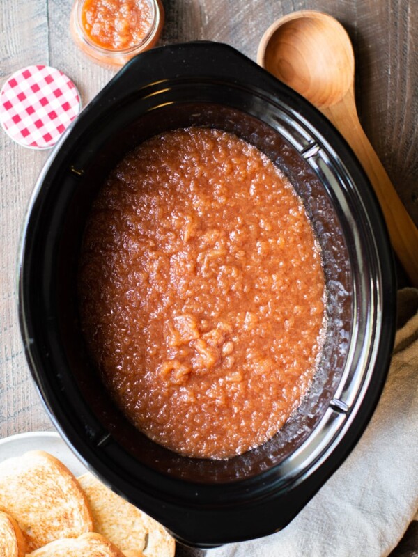 Applesauce in a slow cooker with toast on the side.
