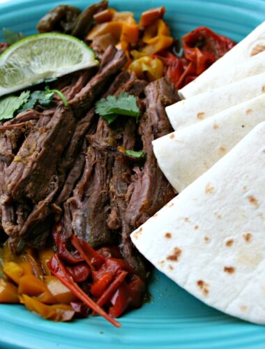 Steak Fajitas with tortillas on plate