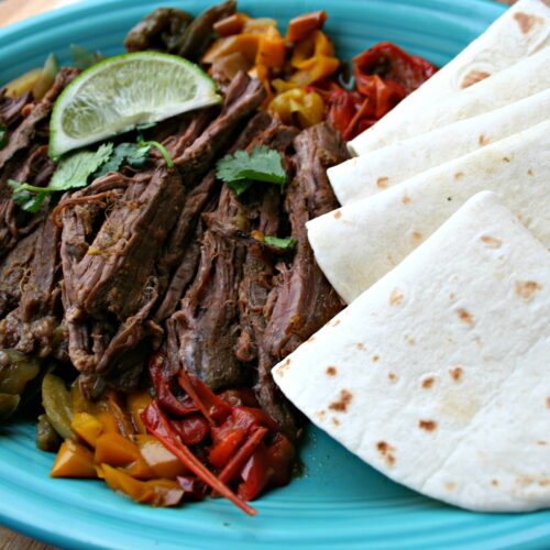 Steak Fajitas with tortillas on plate