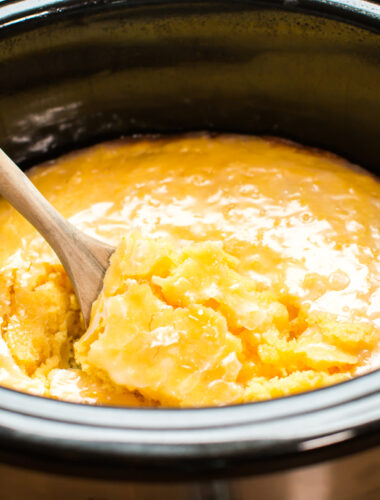 Lemon Spoon Cake with glaze in slow cooker with wooden spoon inside