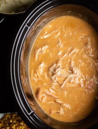 Close up of chicken and gravy in a slow cooker.