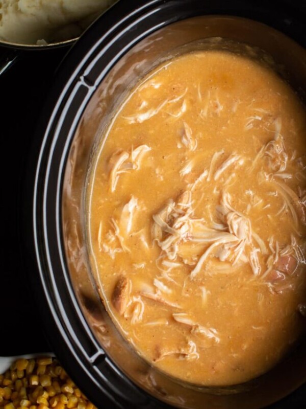 cooked chicken and gravy in slow cooker.