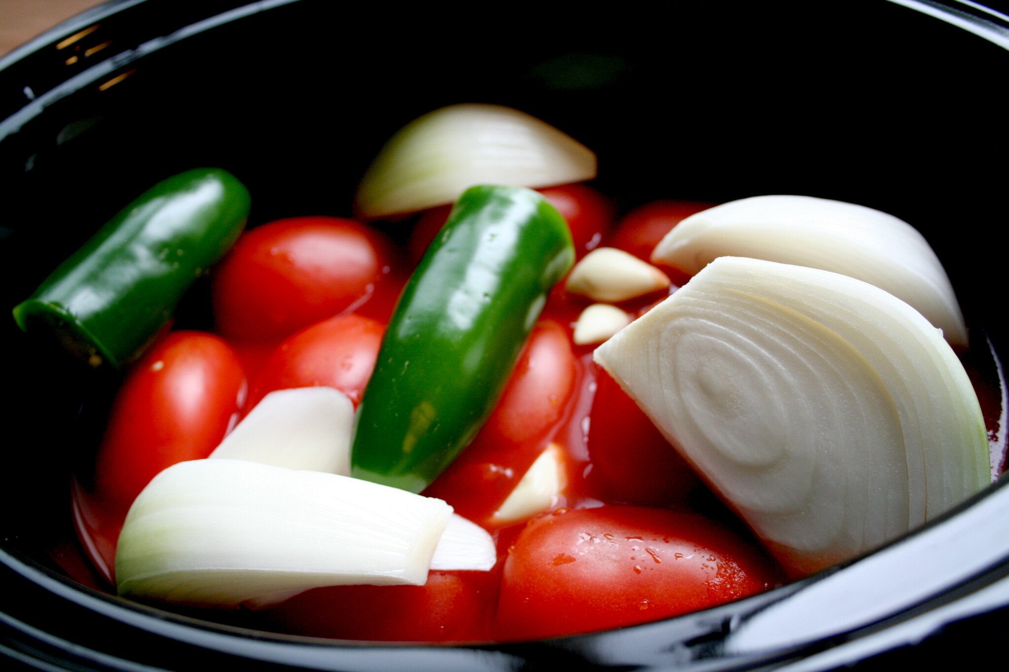 tomatoes, onions, garlic, jalapeno in slow cooker