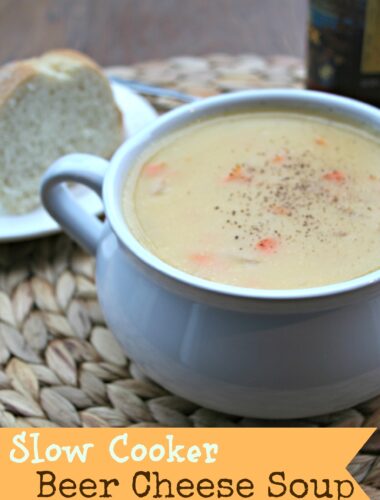 Beer Cheese Soup in white bowl with bread on side