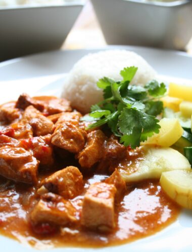 Chicken curry on plate with rice and zucchini