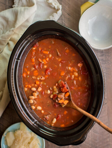 Italian Beef Soup in slow cooker with wooden spoon in it.