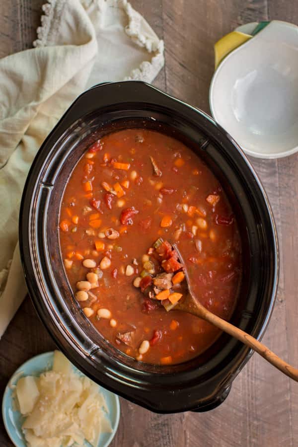 Italian Beef Soup in slow cooker with wooden spoon in it.