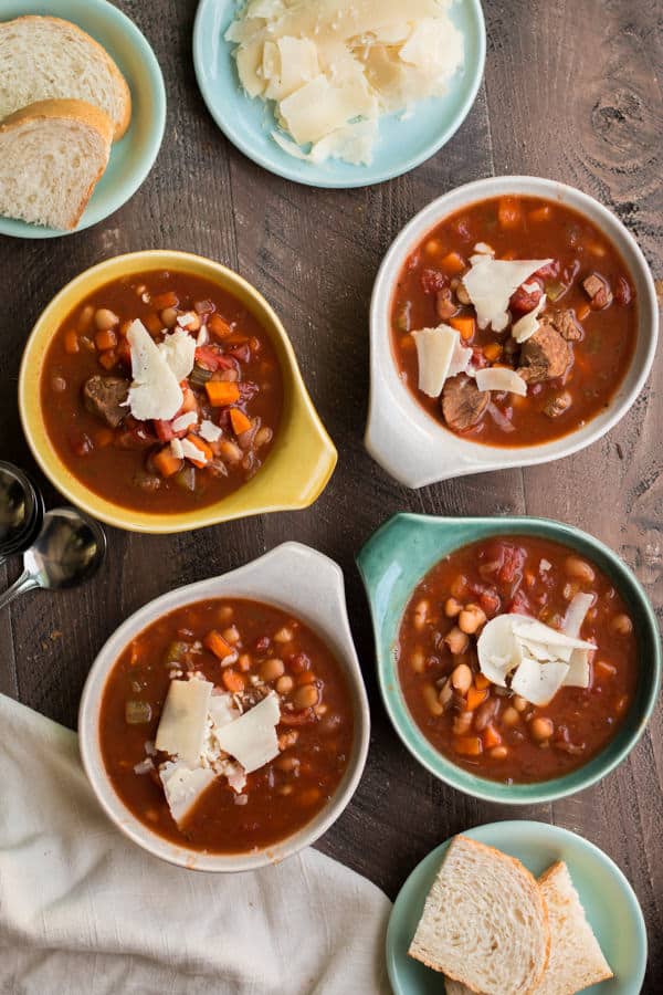 4 bowls of hearty Italian beef soup with parmesan on top