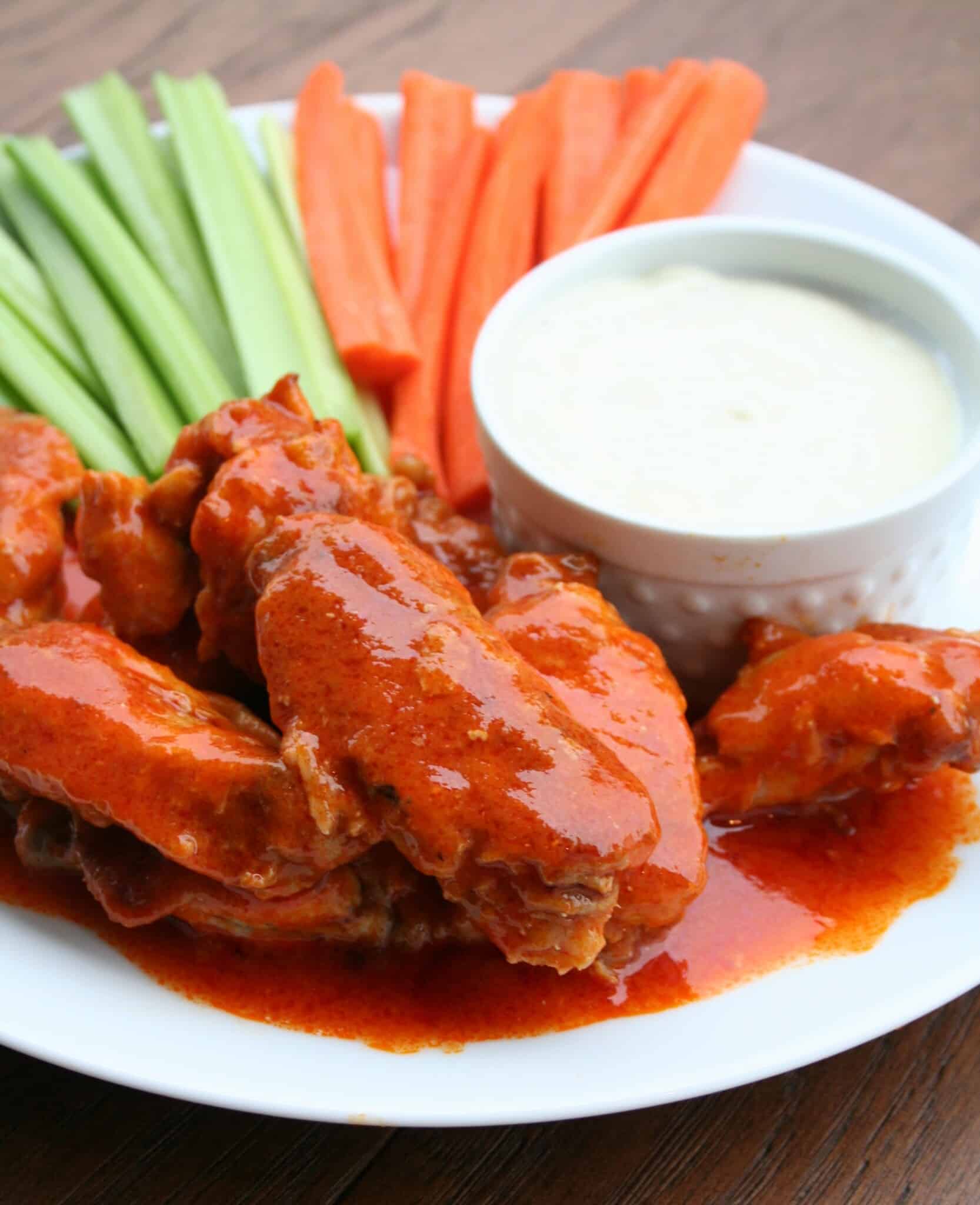 buffalo wings on plate with vegetables and blue cheese dressing