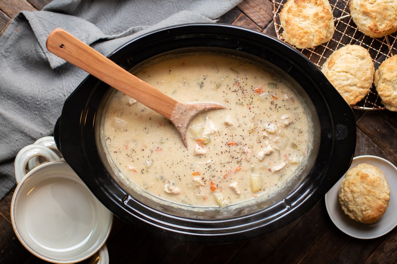Chicken pot pie filling with wooden spoon in it