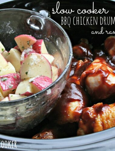 chicken drumsticks in slow cooker with potatoes in glass container on the side of them.