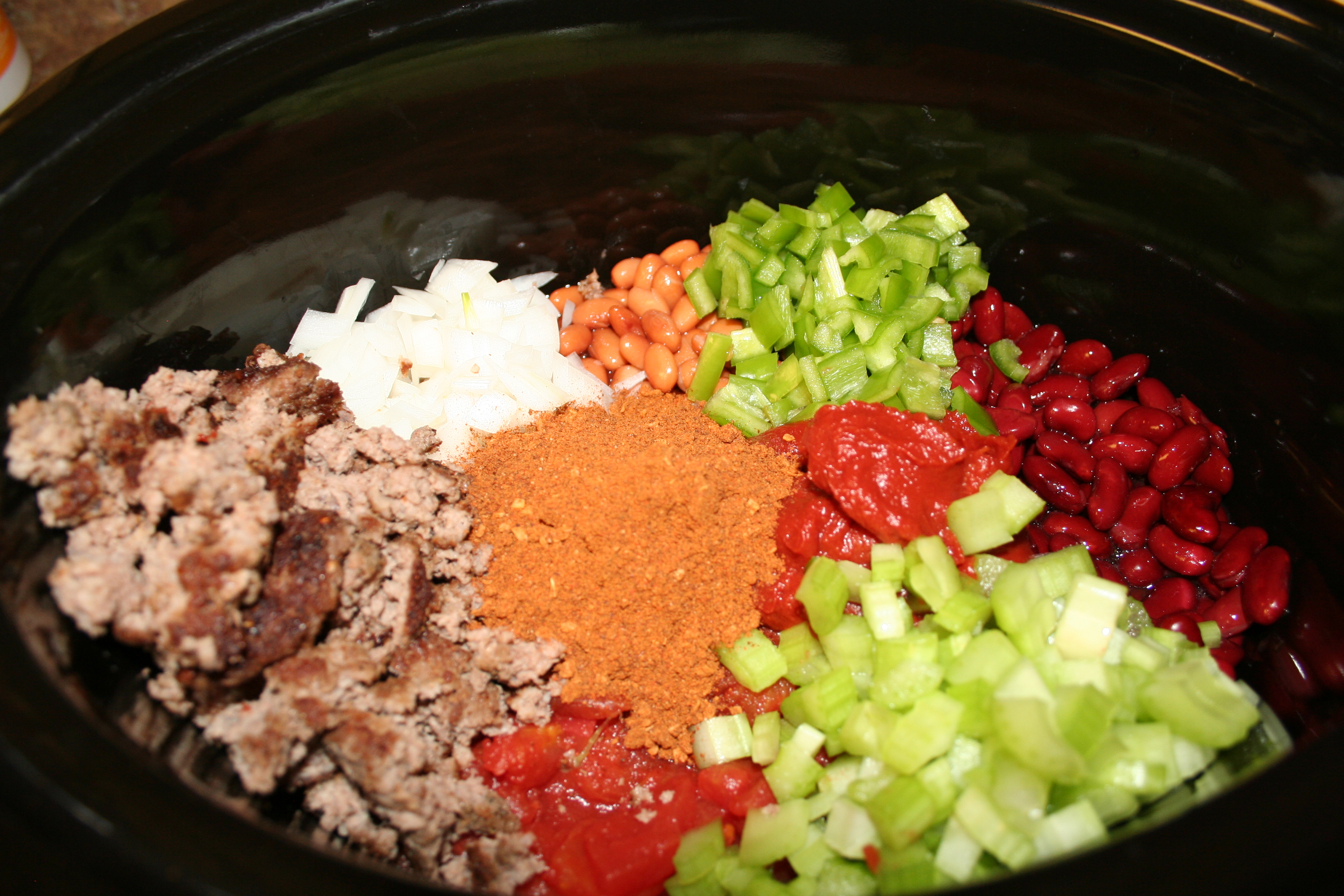 ingredients for wendy's chili in slow cooker not stirred together.