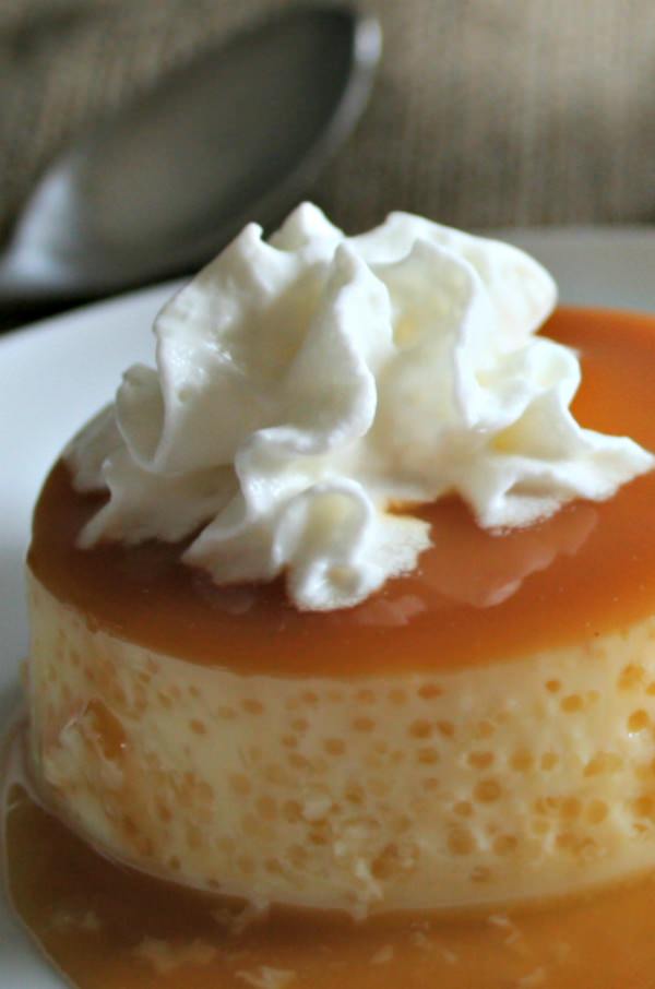 Slow Cooker Caramel Flan on a plate with whipped cream
