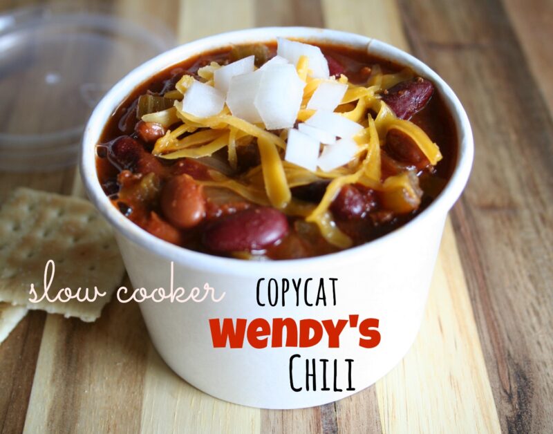 homemade wendy's chili in paper bowl with cheese and onions on top.