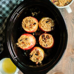 5 apples with granola on top in the slow cooker