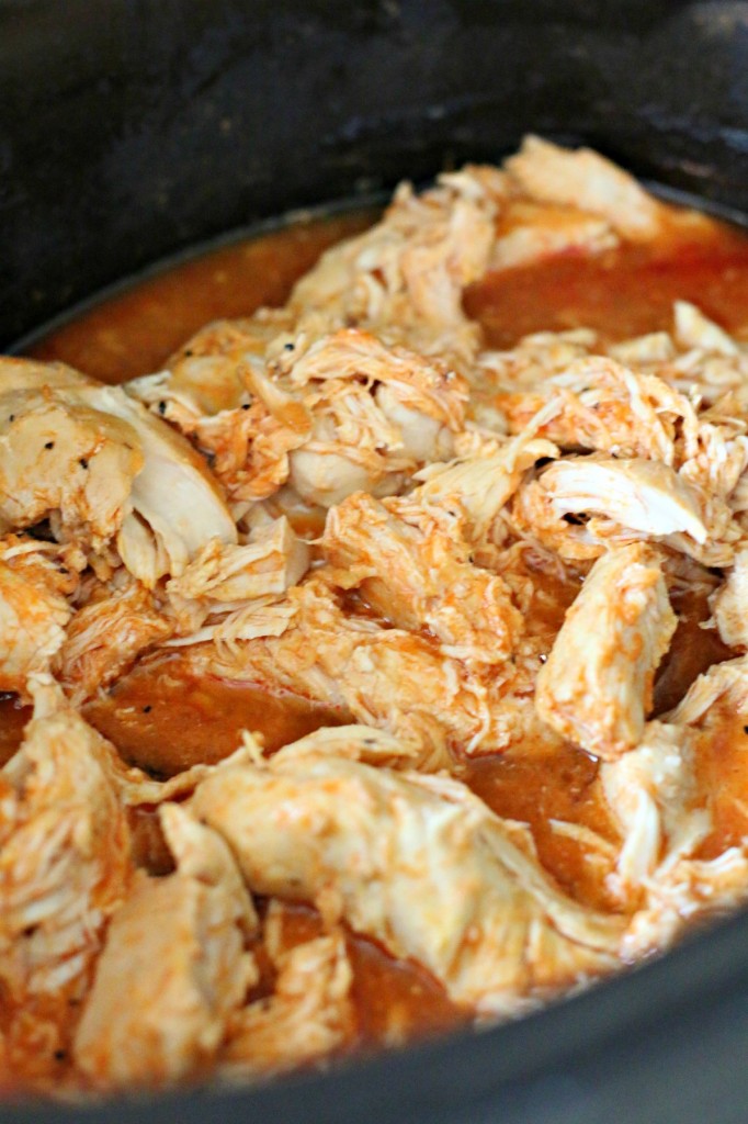 close up of shredded buffalo chicken in crockpot