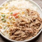 shredded pork, pasta salad and white rice on white plate.