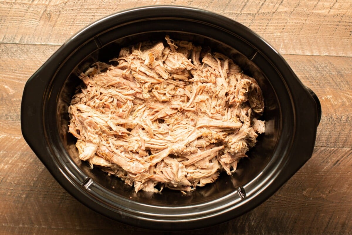 Slow Cooker Kalua Pig, shredded in a slow cooker.