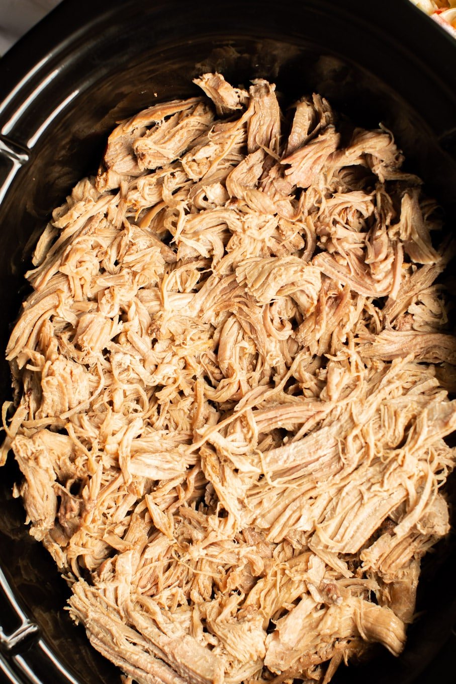 close up of shredded pork in the slow cooker.