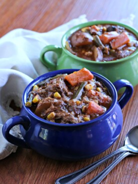 close up of beef stew in blue bowl