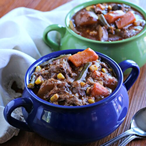 close up of beef stew in blue bowl