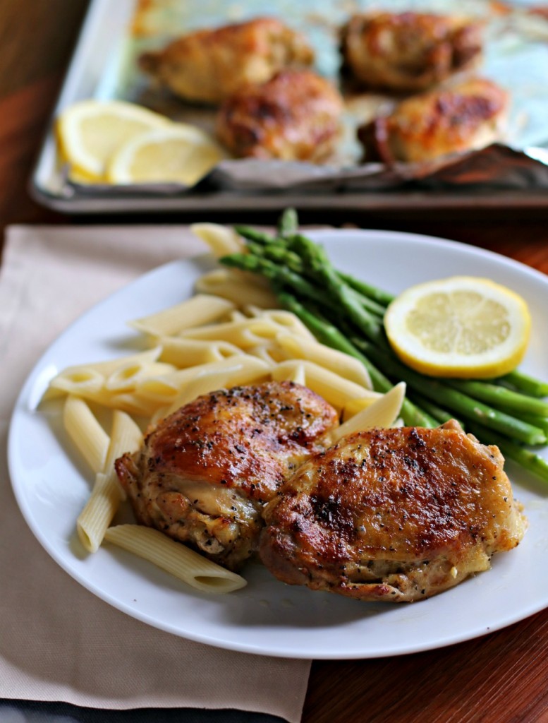 lemon pepper chicken thighs on plate with pasta on side