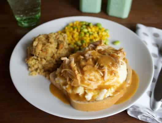 Chicken and Gravy on a plate over bread.