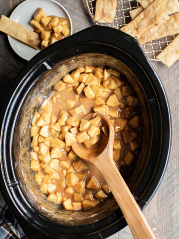 caramel apple dip with wooden spoon in it.