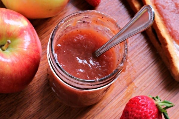 strawberry applesauce in jar with spoon in it