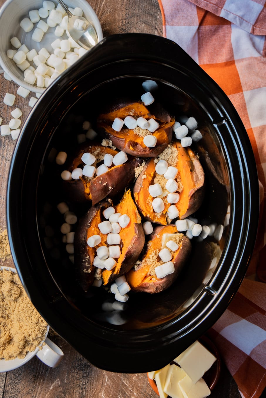 sweet potatoes in the slow cooker, slit open with brown sugar and marshmallows on top.
