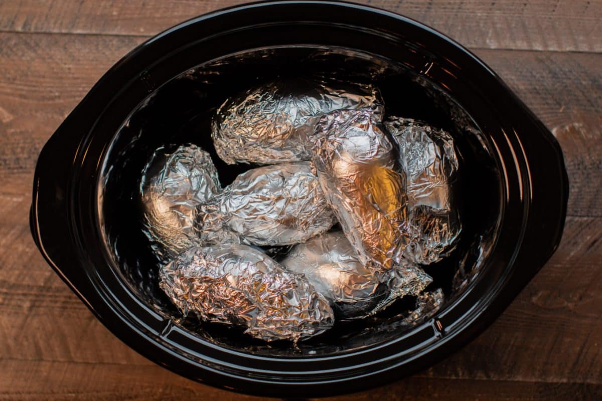 8 sweet potatoes in the slow cooker, wrapped in foil