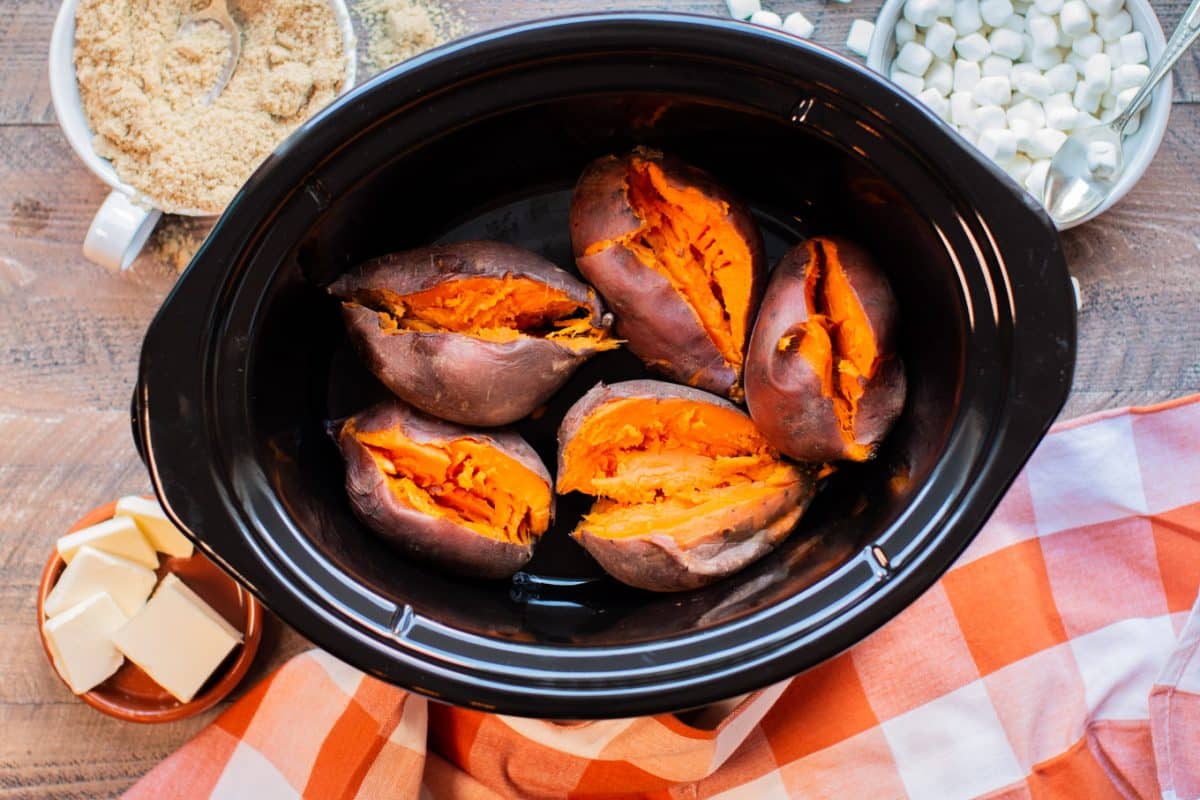 5 sweet potatoes in slow cooker, cooked and slit open