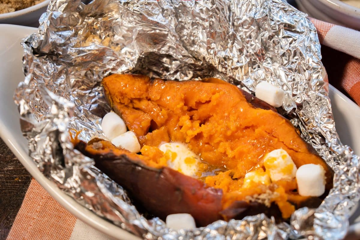 1 sweet potato in foil with melting butter, brown sugar and mini marshmallows.