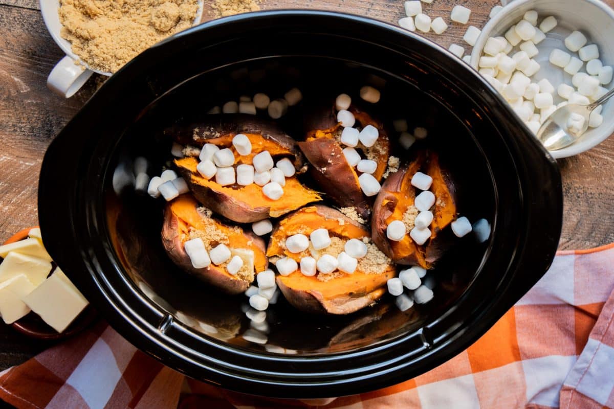sweet potatoes in the slow cooker with brown sugar and mini marshmallows on top.