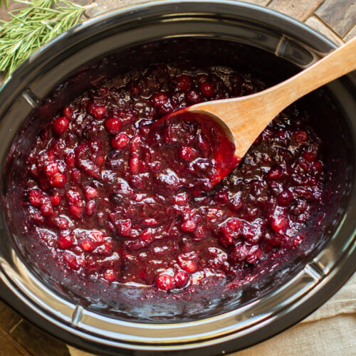 Cooked cranberry sauce in a slow cooker.