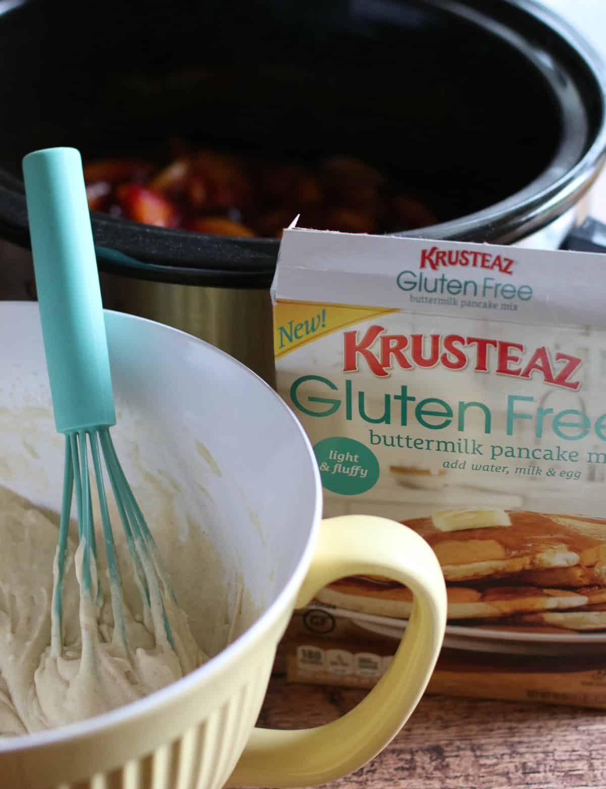 pancake mix in bowl with teal whisk in it