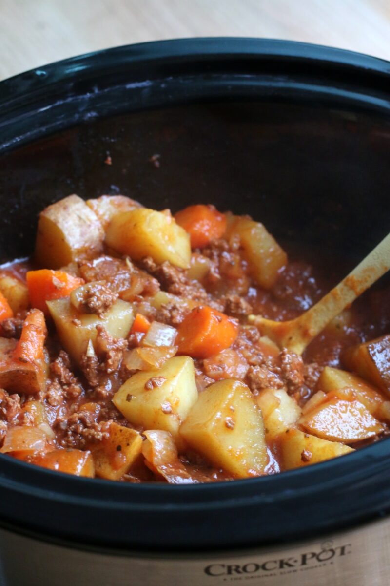 poor man's stew in slow cooker with yellow spoon in it.