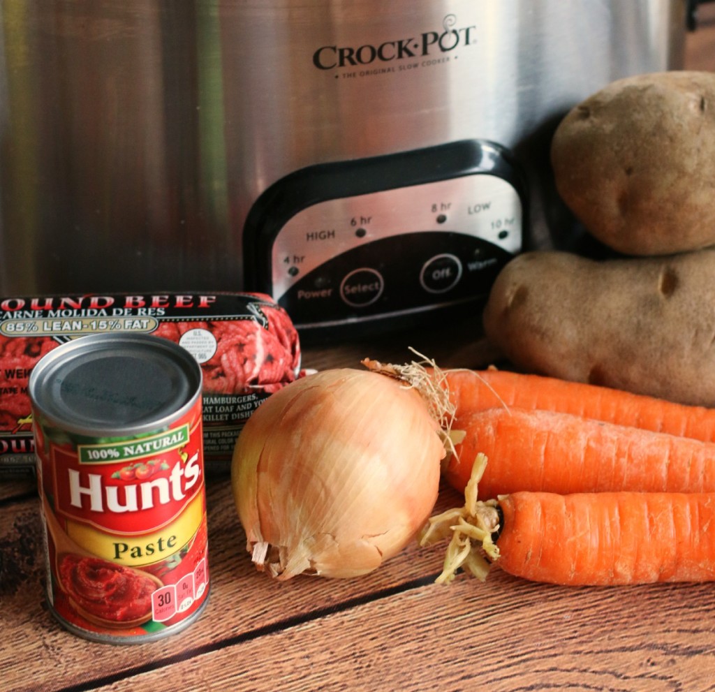 ground beef, tomato paste, carrots, onion and potato in front of slow cooker