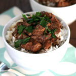 beef tips and gravy of rice in white bowl
