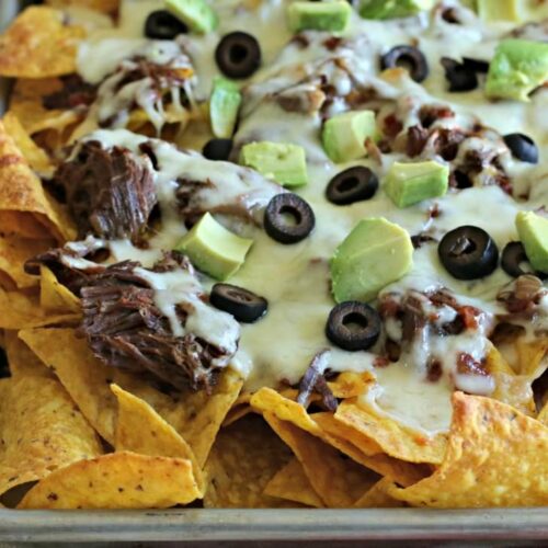 shredded beef nachos on a sheet pan