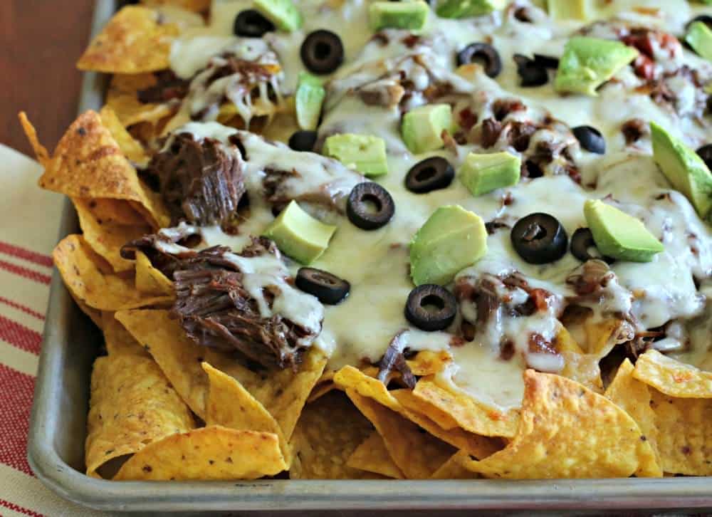 Finished shredded beef nachos on sheet tray