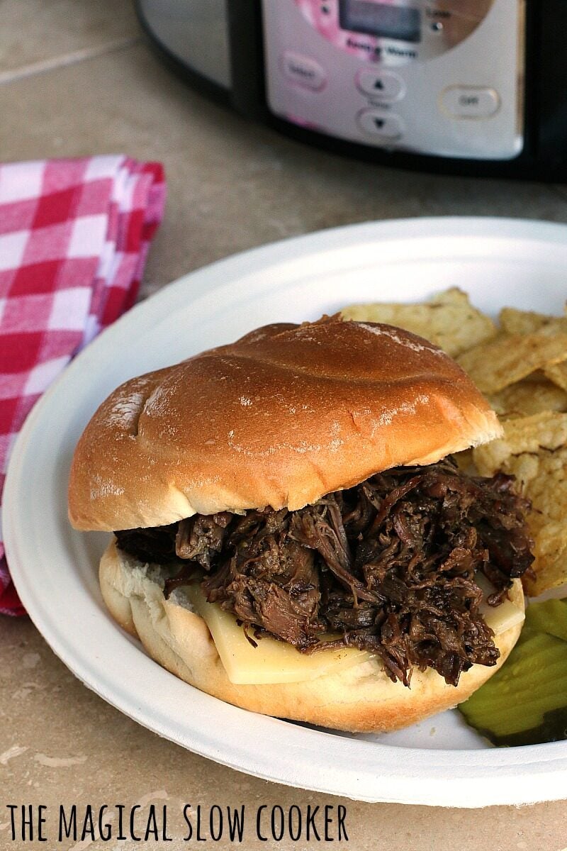 beef sandwich with cheese on paper plate