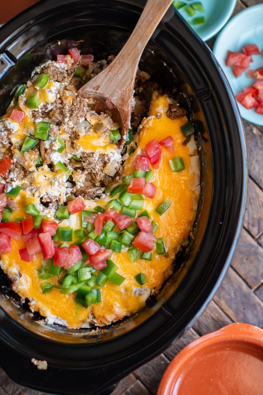 john wayne casserole in an oval slow cooker with wooden spoon in it.