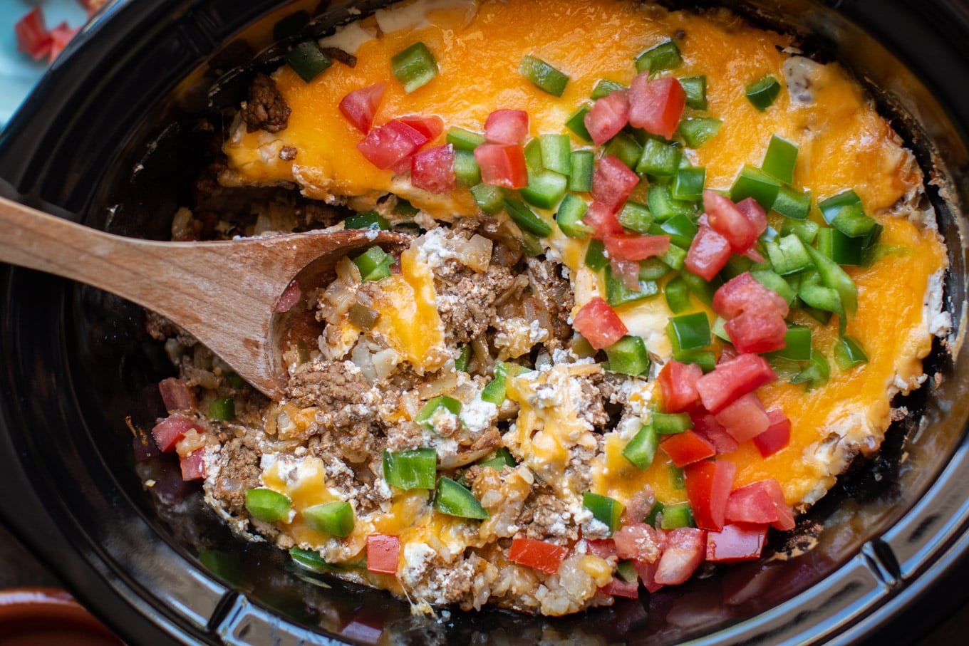 wooden spoon in John Wayne casserole in the slow cooker.